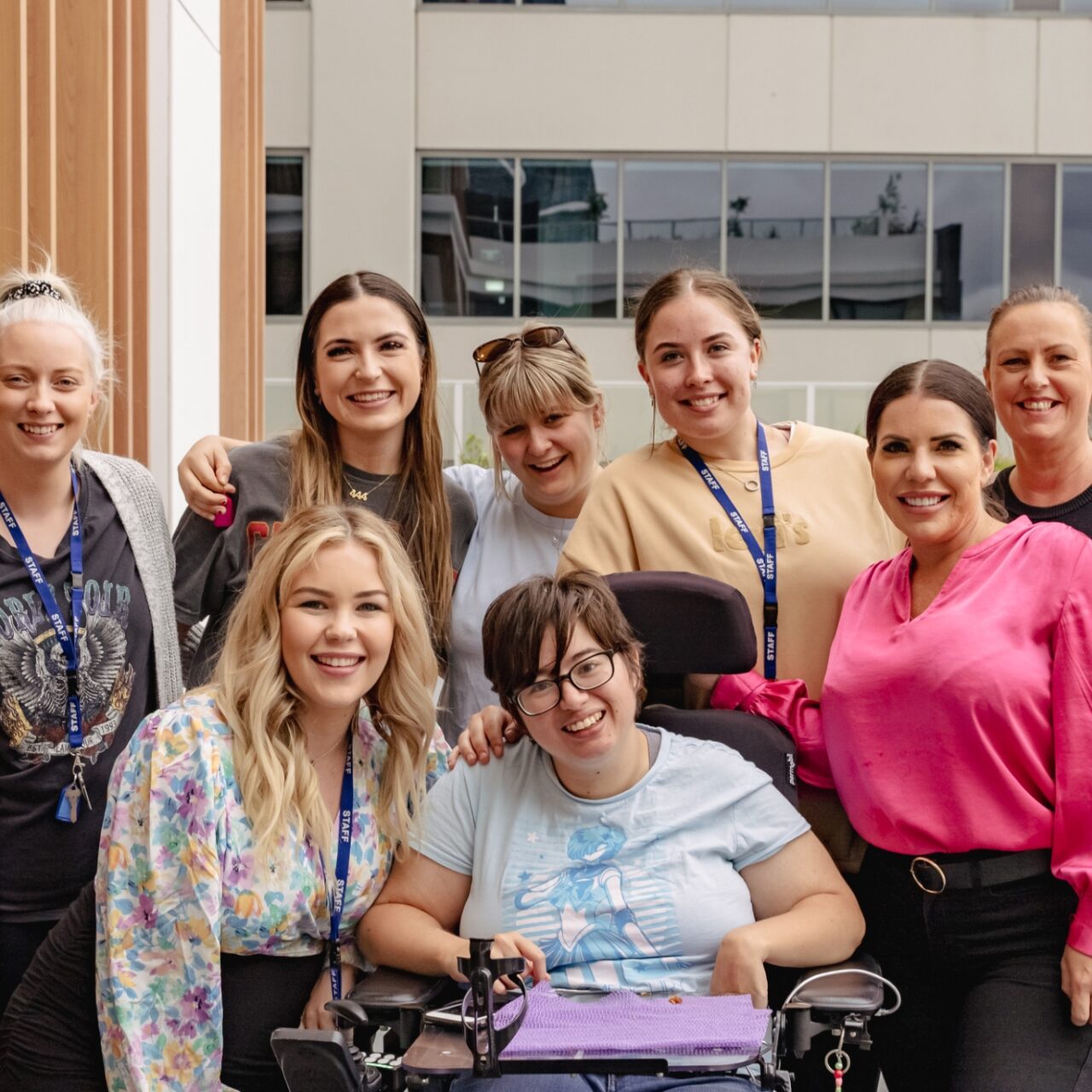 a group of women in a wheelchair posing for a photo.