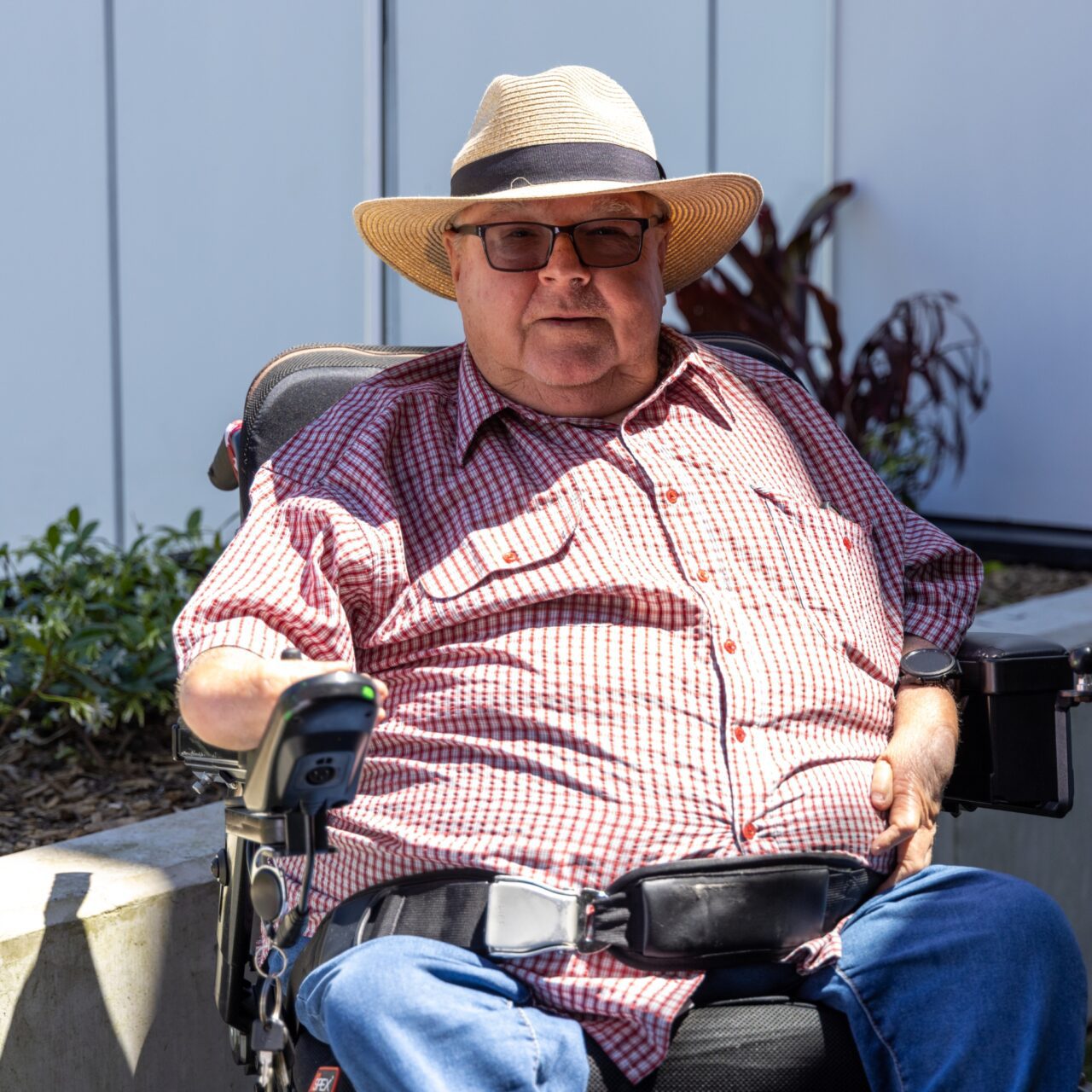 a man in a wheelchair wearing a hat.