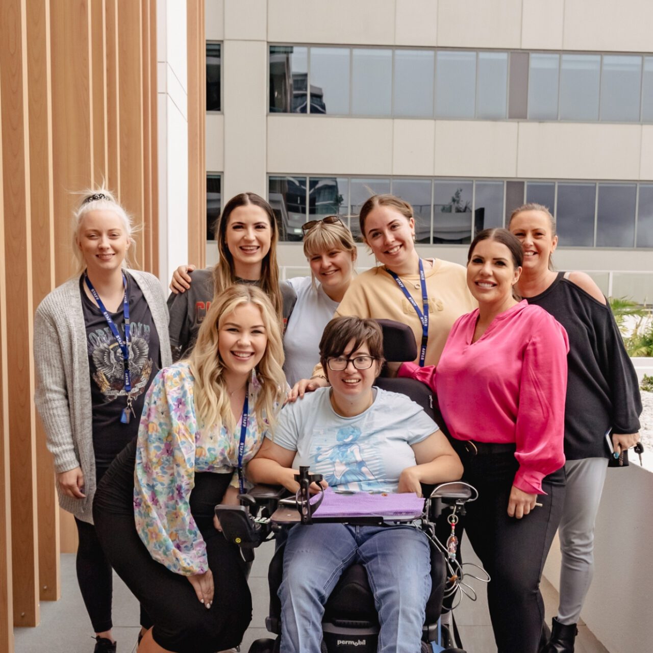 a group of women in a wheelchair posing for a photo.