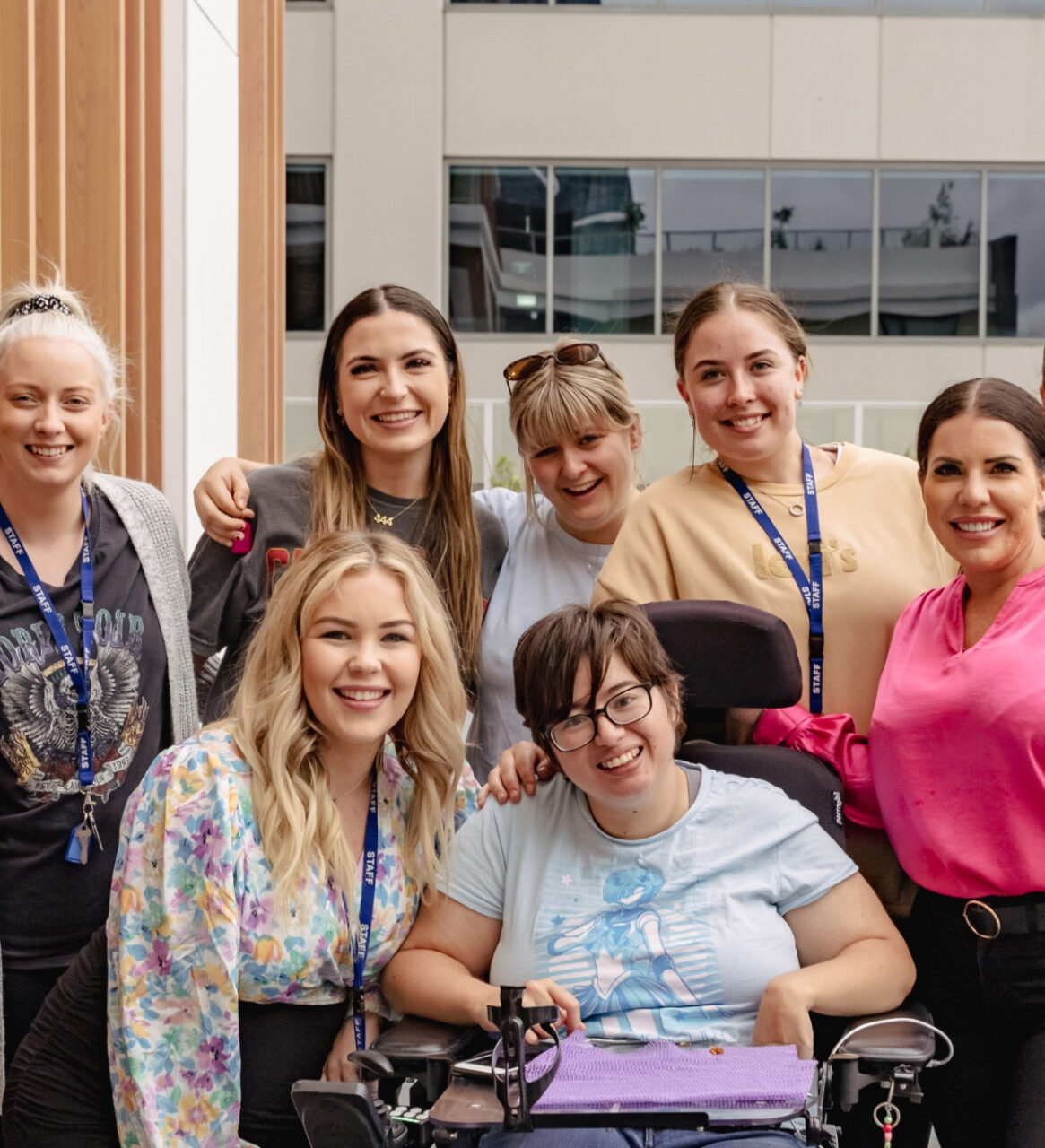 a group of women in a wheelchair posing for a photo.